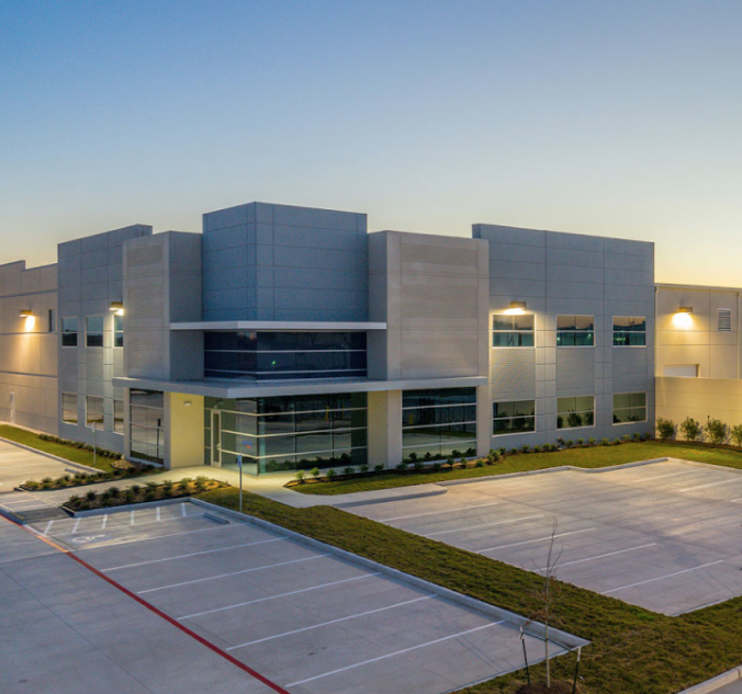 An aerial view of an industrial building at dusk.