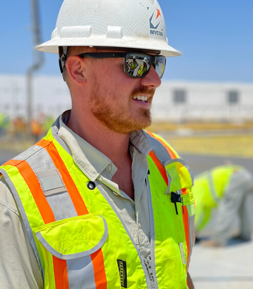 A construction worker wearing a hard hat and safety vest.