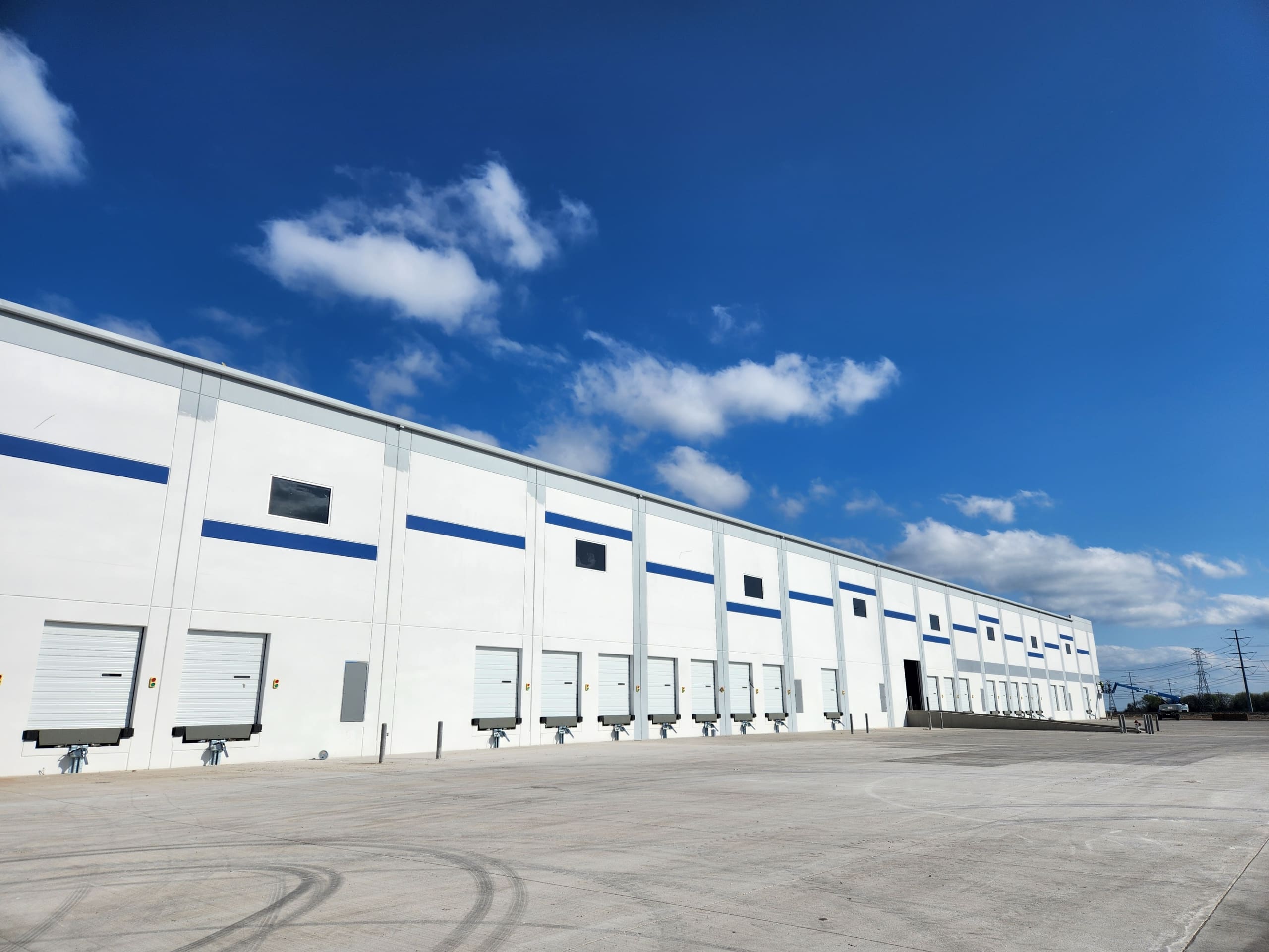 A large warehouse building with blue and white shutters.