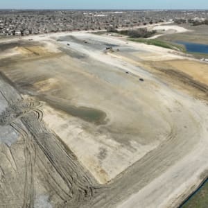 A aerial view of a large area with dirt and water.