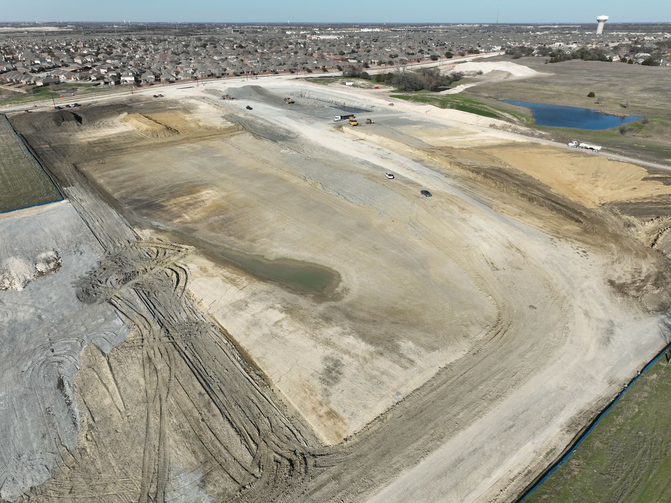 A aerial view of a large area with dirt and water.