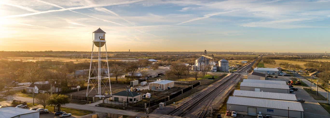 An aerial view of a water tower in a town.