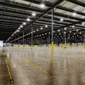 A large warehouse with yellow lines on the floor.