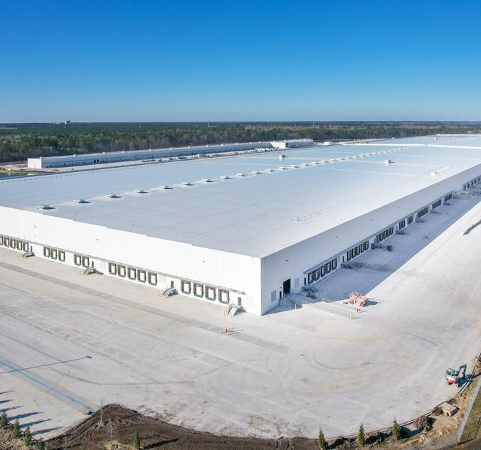 An aerial view of a large white warehouse.