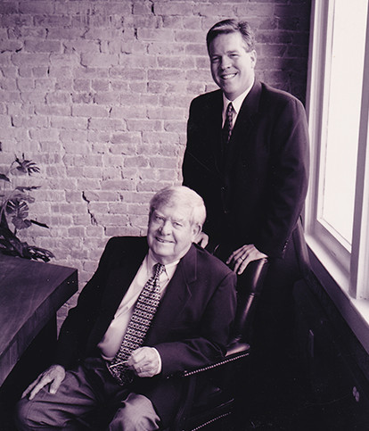 Two men sitting in a chair.