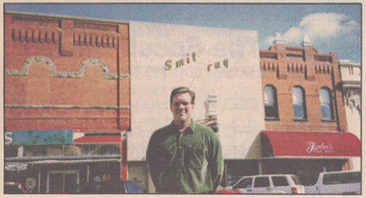 A man standing in front of a building.