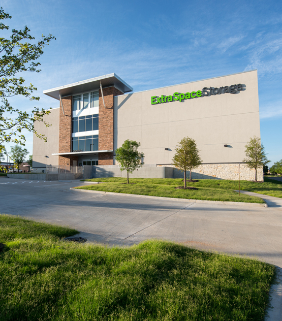 A storage building with a grassy area in front of it.