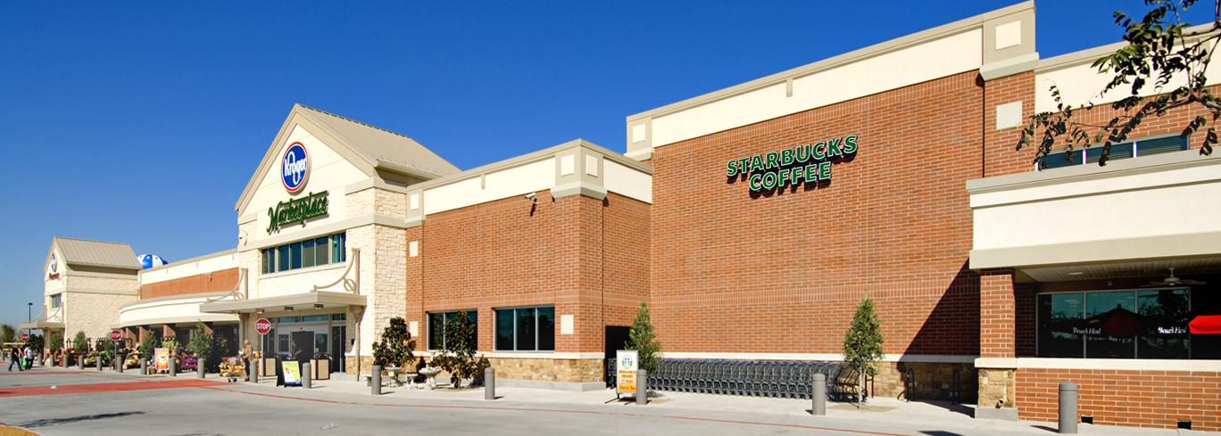 The front of a grocery store with a sign on it.