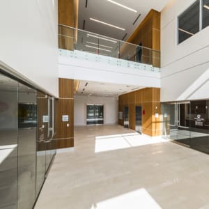 The lobby of a modern office building with glass walls.