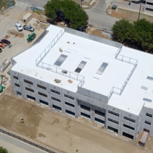An aerial view of a building with a white roof.