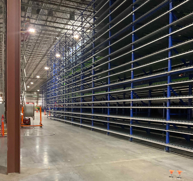 A warehouse with a lot of racks in it.