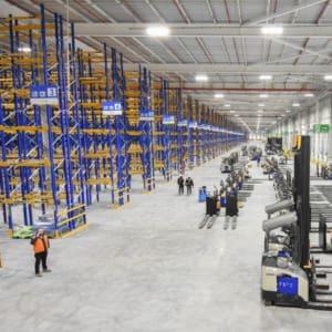 A large warehouse with a lot of pallets.