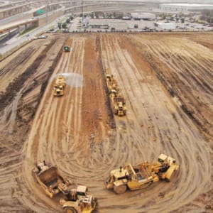 A construction site with several construction vehicles.