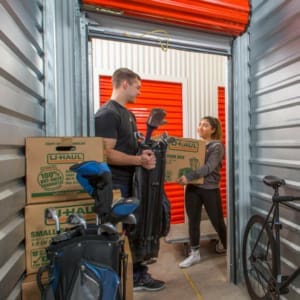 A man and a woman standing in a storage unit.