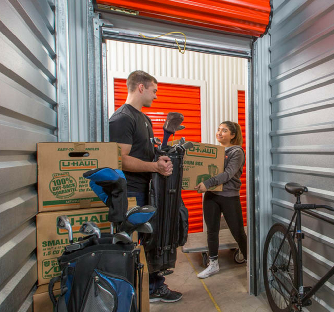 A man and a woman standing in a storage unit.