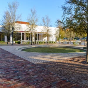 A brick walkway in front of a building.