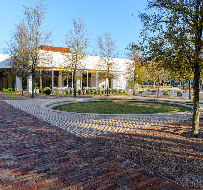 A brick walkway in front of a building.