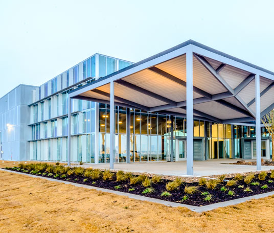 The exterior of a building with a glass roof.