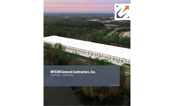 Aerial view of a large industrial building surrounded by trees, featured on the cover of a portfolio for MYCON General Contractors, Inc.